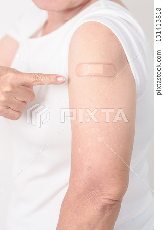 Elderly Woman with bandage after received vaccine. Vaccination and Immunization for Influenza, Herpes Zoster, Tetanus, Covid 19 booster, Dengue, Encephalitis, Rabies, Pneumococcal, IPD, RSV Vaccines 131413818