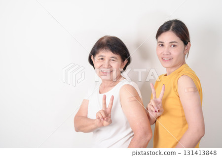 Adult and Elderly Woman with bandage after received vaccine. Vaccination and Immunization for Influenza, HPV, Zoster, IPD, DTP, Dengue, Encephalitis, Rabies, Pneumococcal Hepatitis B and Covid vaccine 131413848