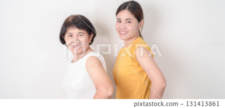 Adult and Elderly Woman with bandage after received vaccine. Vaccination and Immunization for Influenza, HPV, Zoster, IPD, DTP, Dengue, Encephalitis, Rabies, Pneumococcal Hepatitis B and Covid vaccine 131413861