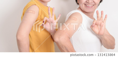 Adult and Elderly Woman with bandage after received vaccine. Vaccination and Immunization for Influenza, HPV, Zoster, IPD, DTP, Dengue, Encephalitis, Rabies, Pneumococcal Hepatitis B and Covid vaccine Adult and Elderly Woman with bandage after received vaccine. Vaccination and Immunization for Influenza, HPV, Zoster, IPD, DTP, Dengue, Encephalitis, Rabies, Pneumococcal Hepatitis B and Covid vaccine 131413864