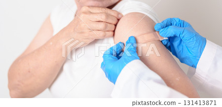 Elderly Woman with bandage after received vaccine. Vaccination and Immunization for Influenza, Herpes Zoster, Tetanus, Covid 19 booster, Dengue, Encephalitis, Rabies, Pneumococcal, IPD, RSV Vaccines 131413871