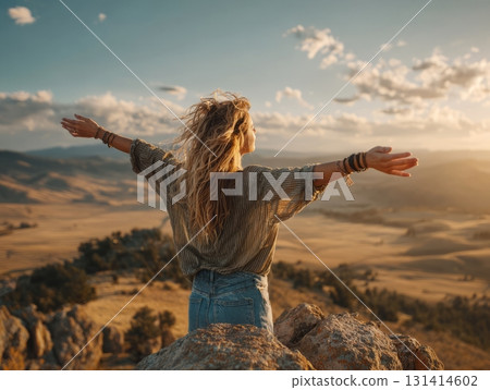 Woman enjoying freedom and peace on mountain summit at sunset Woman enjoying freedom and peace on mountain summit at sunset 131414602