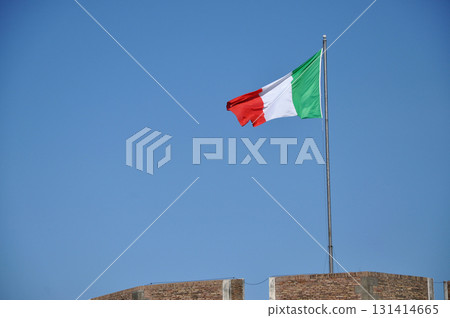Waving flag of Italy against blue sky 131414665