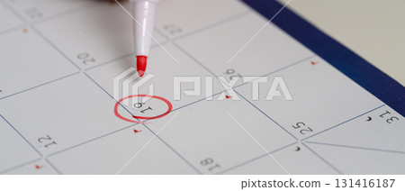 Red pen marking an important date, symbolizing appointment, deadline, or reminder planning. 131416187