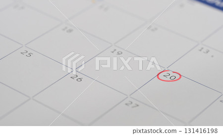 Close up of a calendar page with the 20th day circled in red, representing an important appointment Close up of a calendar page with the 20th day circled in red, representing an important appointment 131416198