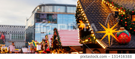 Beautiful traditional German Christmas Market square in city center many carousel Christmas tree light and decoration. Christmas and new year celebration season. Advent festive New year fair Beautiful traditional German Christmas Market square in city center many carousel Christmas tree light and decoration. Christmas and new year celebration season. Advent festive New year fair 131416388