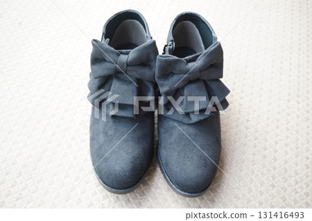 This stock photo shows short boots with striking large black ribbons photographed from directly above and aligned to the left and right. This stock photo shows short boots with striking large black ribbons photographed from directly above and aligned to the left and right. 131416493
