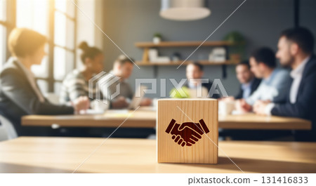 Business agreement and partnership concept with handshake icon on wood cube. Successful deal, negotiation and collaboration after corporate team meeting in modern office background Business agreement and partnership concept with handshake icon on wood cube. Successful deal, negotiation and collaboration after corporate team meeting in modern office background 131416833