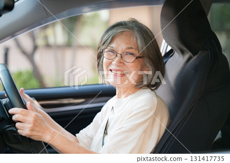 Elderly women driving a car 131417735