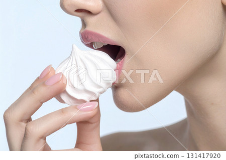 woman eating a meringue 131417920