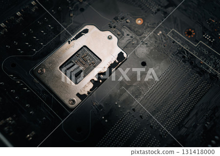 Close-up of motherboard CPU socket, revealing intricate traces, electronic components, complex circuitry that powers modern computing. Concept of modern technology. Close-up of motherboard CPU socket, revealing intricate traces, electronic components, complex circuitry that powers modern computing. Concept of modern technology. 131418000