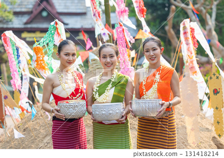 Songkran festival. Portrait Northern Thai people in Traditional clothes dressing handle handcrafted silver bowl in Songkran day summer Thailand cultural festival. 131418214
