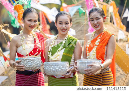 Songkran festival. Portrait Northern Thai people in Traditional clothes dressing handle handcrafted silver bowl in Songkran day summer Thailand cultural festival. 131418215