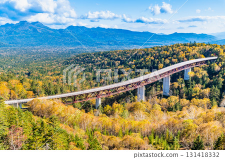 Hokkaido's Mikuni Pass: Matsumi Bridge and the Daisetsu Mountain Range, colored by autumn leaves 131418332