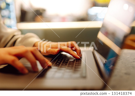 A young woman is engaged in typing on a laptop. Cyber security. Business, Freelance, Shopping A young woman is engaged in typing on a laptop. Cyber security. Business, Freelance, Shopping 131418374