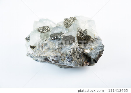 Fluorite mineral stone with cubic crystals and pyrite inclusions, a natural calcium fluoride specimen displayed on a white background. 131418465