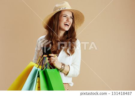 happy elegant woman in blouse and shorts on beige 131418487