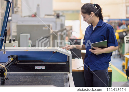 Asian women worker work in heavy industry with CNC lathe milling metal machine in steel product factory Asian women worker work in heavy industry with CNC lathe milling metal machine in steel product factory 131418654