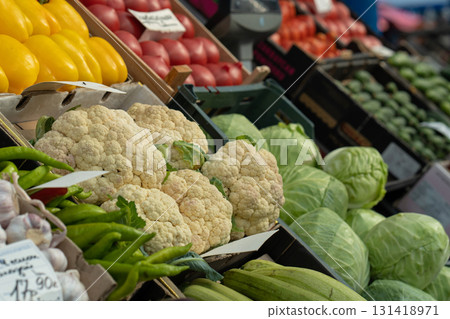 Fresh cauliflower for sale. Cauliflower at a vegetable stand at a farmers' market, or in the produce section of a supermarket or grocery store. 131418971