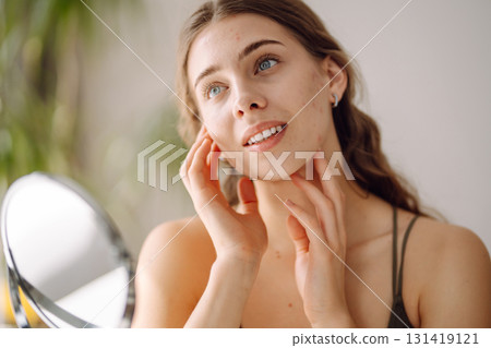 Woman worry about her face when she saw the problem of acne occur by a mini mirror. Pimples, acne Woman worry about her face when she saw the problem of acne occur by a mini mirror. Pimples, acne 131419121