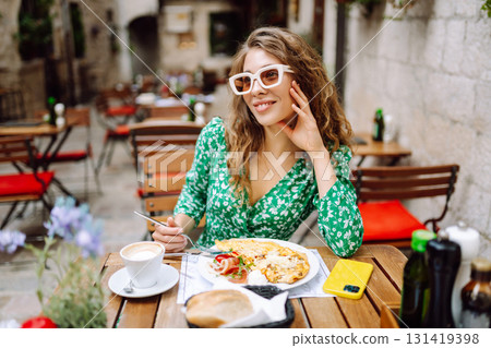 Young Woman eating Italian pasta at restaurant on the street in Rome. Gastronomy and travel Young Woman eating Italian pasta at restaurant on the street in Rome. Gastronomy and travel 131419398