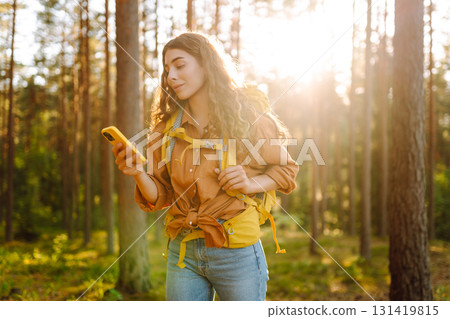 Young woman using smartphone and enjoying autumn weather in the park. Blogging, technology. Young woman using smartphone and enjoying autumn weather in the park. Blogging, technology. 131419815