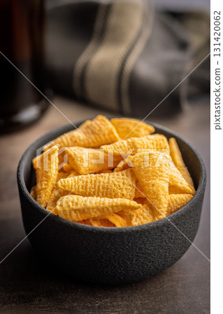 Bugles snack. Cone corn chips in bowl on kitchen table. Bugles snack. Cone corn chips in bowl on kitchen table. 131420062