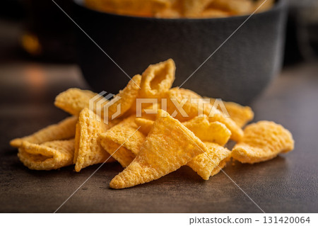 Bugles snack. Cone corn chips on kitchen table. 131420064