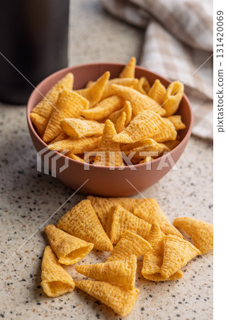 Bugles snack. Cone corn chips on kitchen table. Bugles snack. Cone corn chips on kitchen table. 131420069