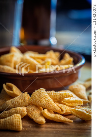 Bugles snack. Cone corn chips on wooden table. Bugles snack. Cone corn chips on wooden table. 131420078