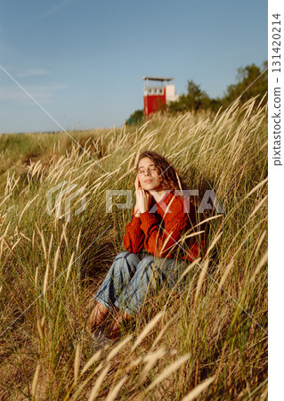 Happy woman enjoying nature outdoors in tall grass. Flying hairs. Outdoor. Fashion style. Happy woman enjoying nature outdoors in tall grass. Flying hairs. Outdoor. Fashion style. 131420214