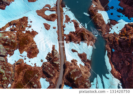 Top view of mountain road. The mountain is covered with melting snow. Abstract nature background 131420750