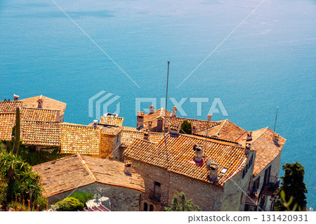 The medieval village of Eze in France. Ancient houses with tiled roofs against the backdrop of the sea 131420931