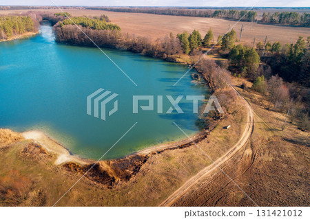 Lakeshore in autumn. View from above of small lake and dirt road. Nature landscape. Nature background 131421012