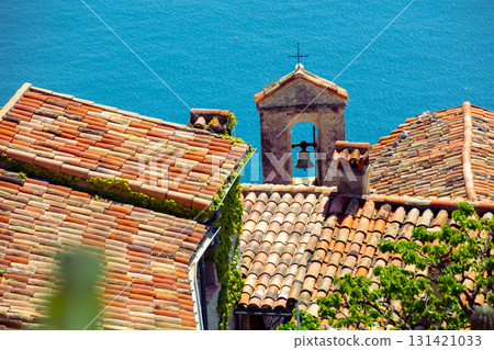 The medieval village of Eze in France. Ancient houses with tiled roofs against the backdrop of the sea The medieval village of Eze in France. Ancient houses with tiled roofs against the backdrop of the sea 131421033