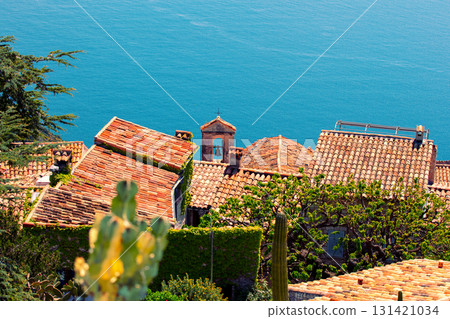 The medieval village of Eze in France. Ancient houses with tiled roofs against the backdrop of the sea 131421034