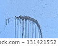 The coarse texture of a dark blue wall with a bold stain. The rough texture of a deep blue wall with an ink blot. The concept of background and textured surface. 131421552