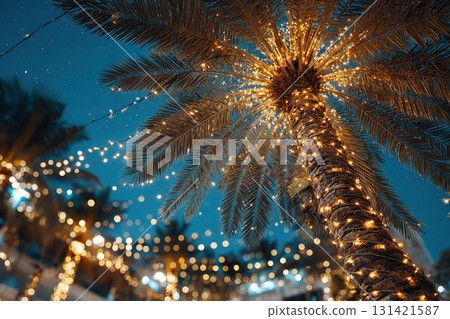 A coconut palm tree draped in a garland of lights against the night sky. Beach party. Christmas and New Year's. 131421587