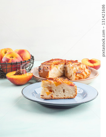 Piece of nectarine peach cake on turquoise table Piece of nectarine peach cake on turquoise table 131421686
