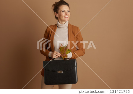 Elegant Businesswoman with Briefcase and Fall Foliage 131421735
