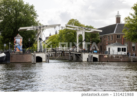 Charming Drawbridge Over Calm Waters in a Scenic Cityscape of Amsterdam 131421988