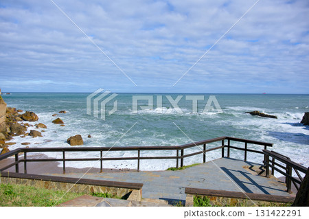 Wooden terrace overlooking scenic ocean waves Wooden terrace overlooking scenic ocean waves 131422291