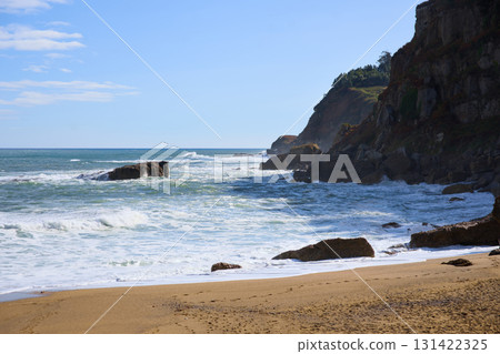 Scenic sandy beach with rocky coastline 131422325