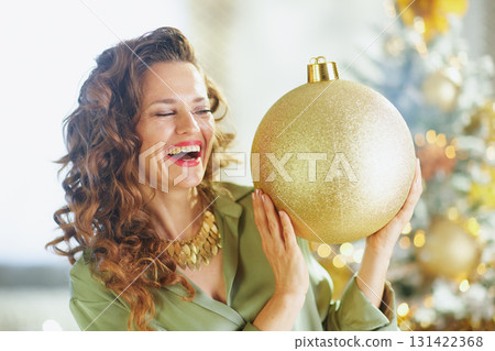 Laughing Woman with Glittery Christmas Ornament 131422368