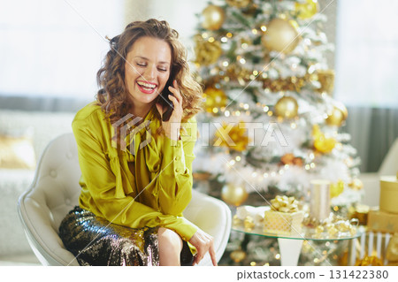 Elegant Woman Making a Joyful Holiday Phone Call Elegant Woman Making a Joyful Holiday Phone Call 131422380