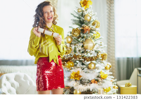 Festive Woman Holding a Christmas Cracker 131422383
