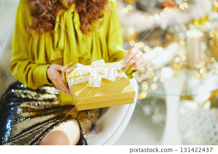 Festive Elegance: Golden Gift Box Moment 131422437