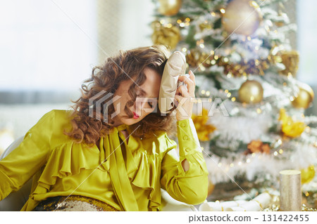 Woman Resting Head Amidst Christmas Decor Woman Resting Head Amidst Christmas Decor 131422455
