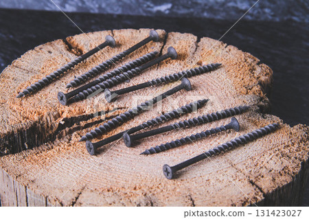 Fasteners for wood. Self-tapping screws on a wooden table. Fasteners for wood. Self-tapping screws on a wooden table. 131423027