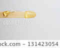 The inscription cosmetology on a wooden spatula with wax for hair removal. 131423054